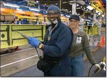 Cecil Tucker (left) and Debra Krause, who seal spars in the Renton, Wash., factory