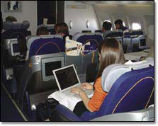 people sitting in a Lufthansa airplane using internet access